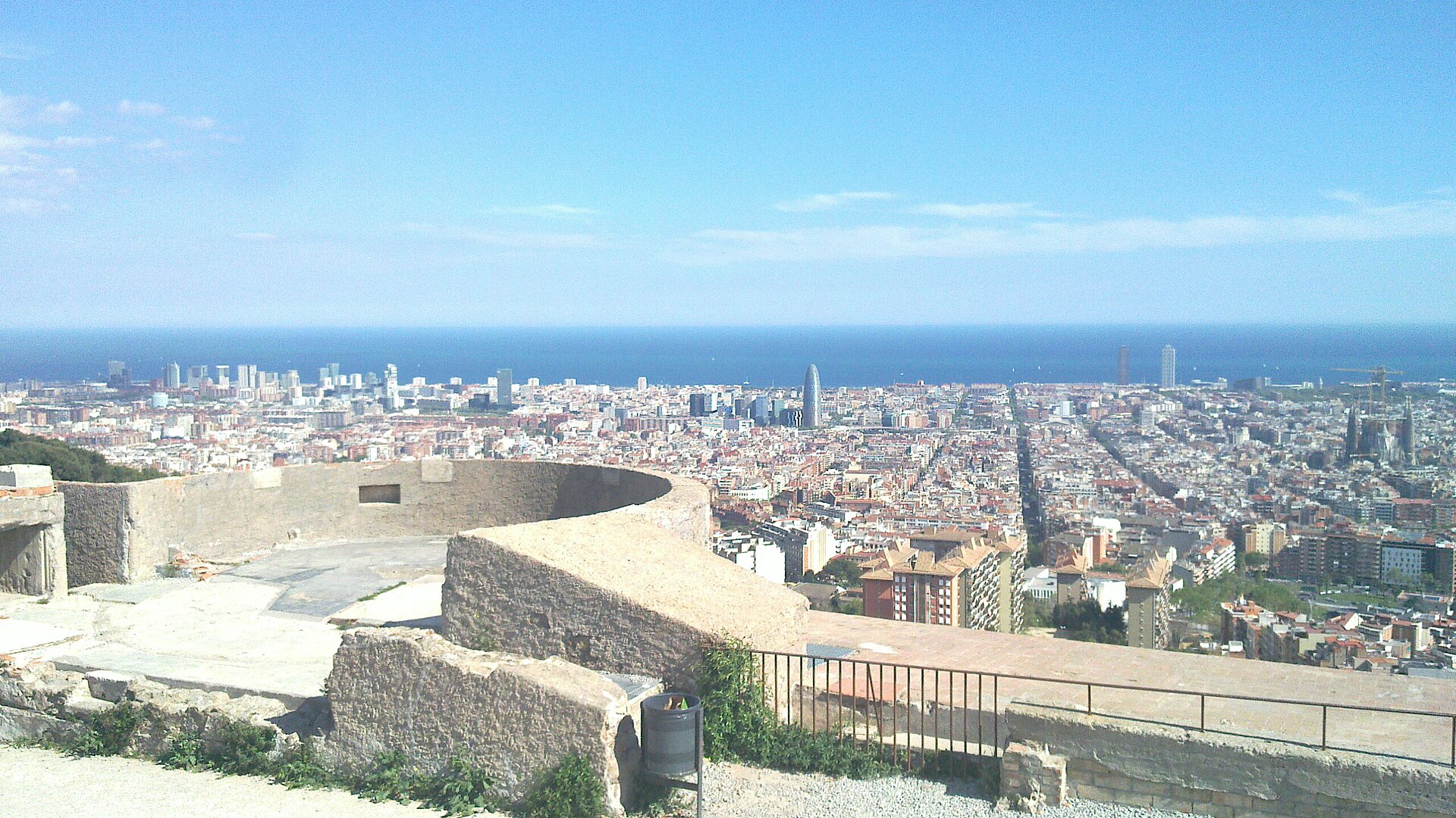 Concrete remains of the old anti-aircraft battery on Turó de la Rovira, with Barcelona and the sea behind